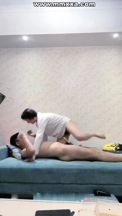 Guy and young woman having sex on sofa in living room